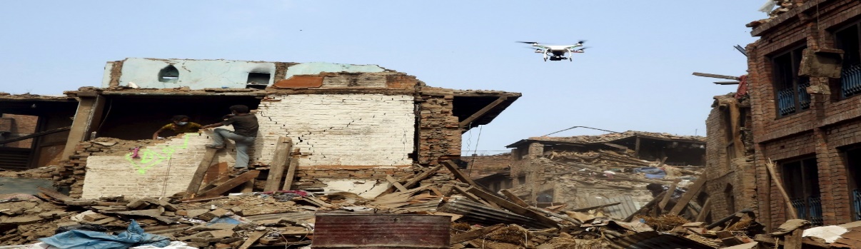 A drone flying over a destroyed building

Description automatically generated